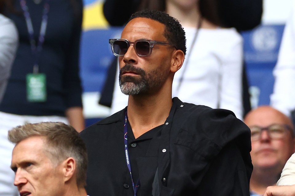 a man wearing sunglasses and a lanyard with the word uefa on it