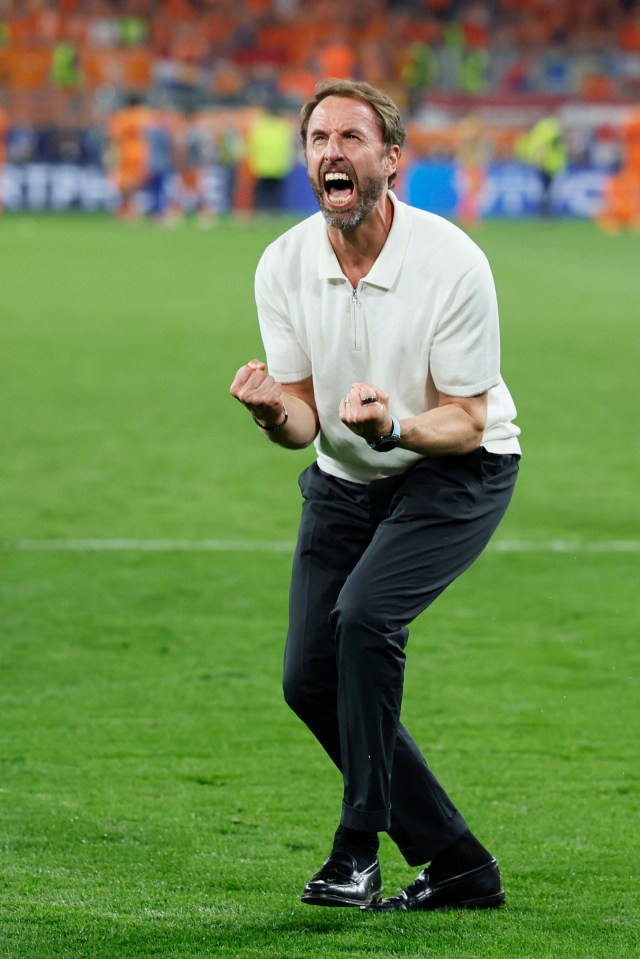 a man in a white shirt is screaming on a soccer field