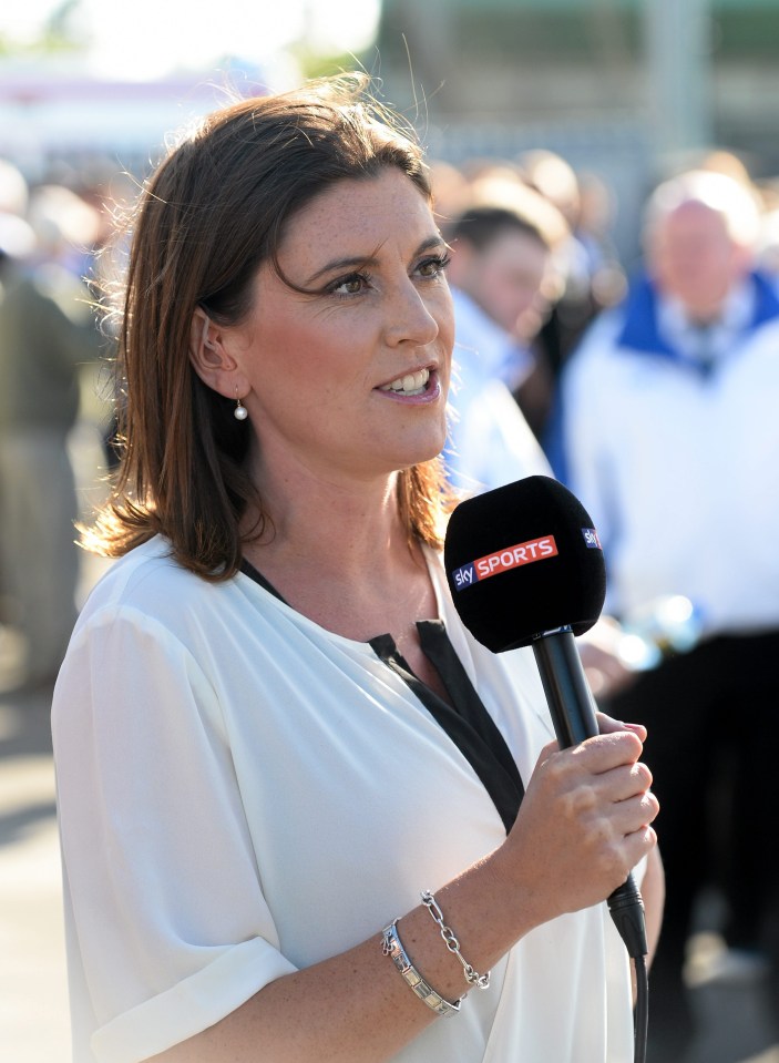 a woman holding a microphone that says sky sports on it