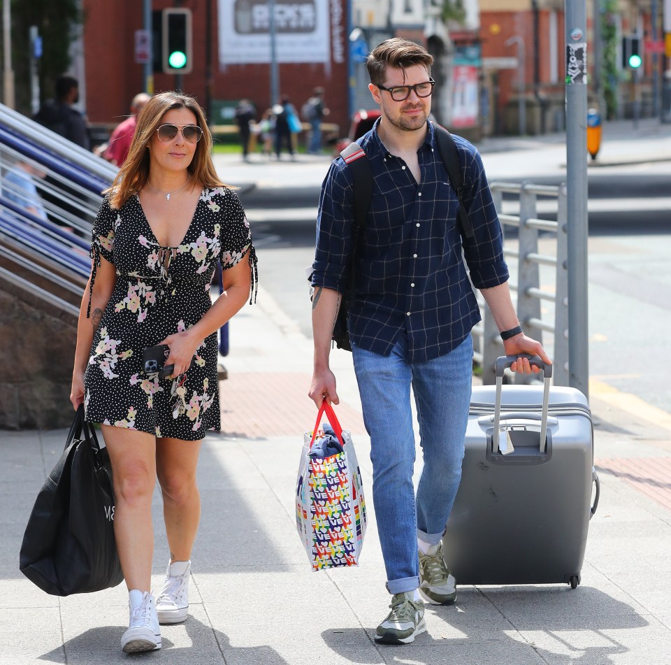 Kym was seen helping Samuel with his luggage as they headed home