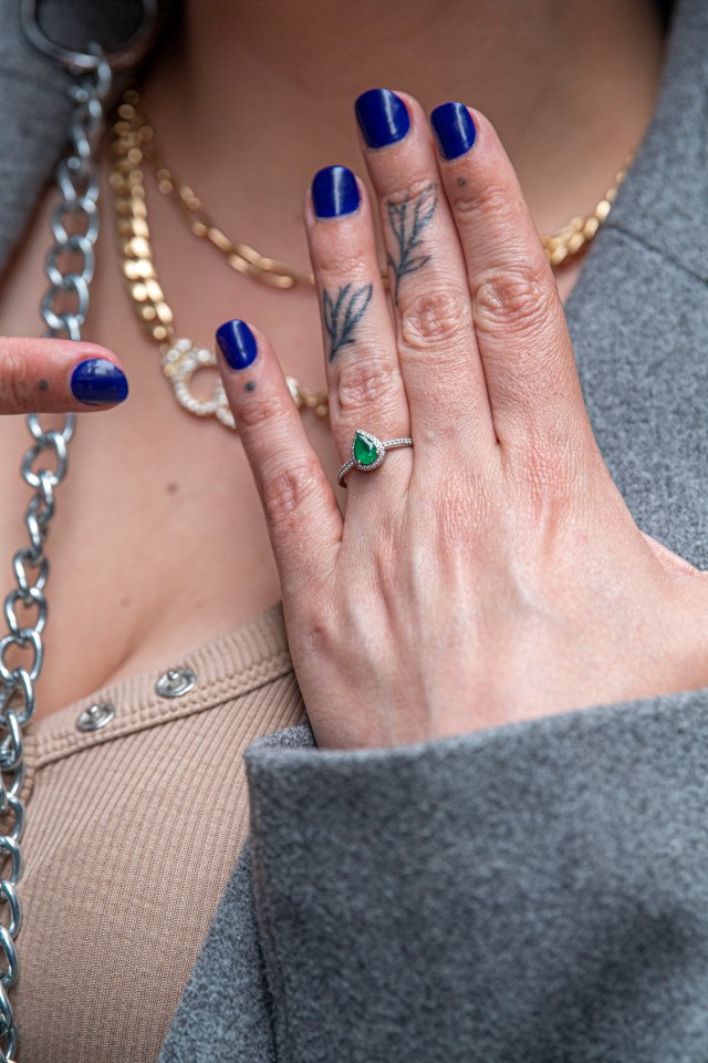 The EastEnders actress beamed as she showed off her new diamond and emerald engagement ring.