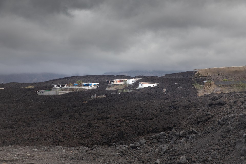 Picture shows houses in the middle of the lava of the Tajogaite volcano in the Llanos de Aridane, on the Canary Island of La Palma, on September 14, 2022. - Yet as for many on the tiny isle, part of the Canary Islands which lie off Africas northwest coast, life remains difficult and the future uncertain since the eruption of the Tajogaite volcano, previously known as Cumbre Vieja for the ridge on which it sits, which will mark its first anniversary on September 19, 2022. (Photo by Desiree MARTIN / AFP) (Photo by DESIREE MARTIN/AFP via Getty Images)