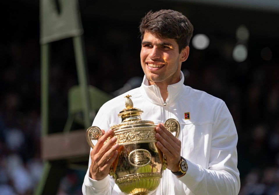 WIMBLEDON, LONDON, ENGLAND - JULY 14: Carlos Alcaraz of Spain holds the trophy after defeating Novak Djokovic of Serbia in the Mens Singles Final on Day 14 at All England Lawn Tennis and Croquet Club on July 14, 2024 in Wimbledon, London, England. (Photo by Fred Mullane/ISI Photos/Getty Images)