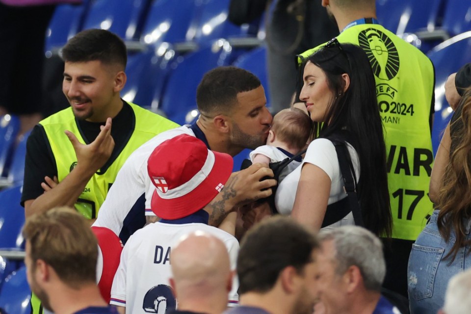 GELSENKIRCHEN, GERMANY - JUNE 30: Kyle Walker of England interacts with his child and his wife Annie Kilner after the UEFA EURO 2024 round of 16 match between England and Slovakia at Arena AufSchalke on June 30, 2024 in Gelsenkirchen, Germany. (Photo by Richard Pelham/Getty Images)