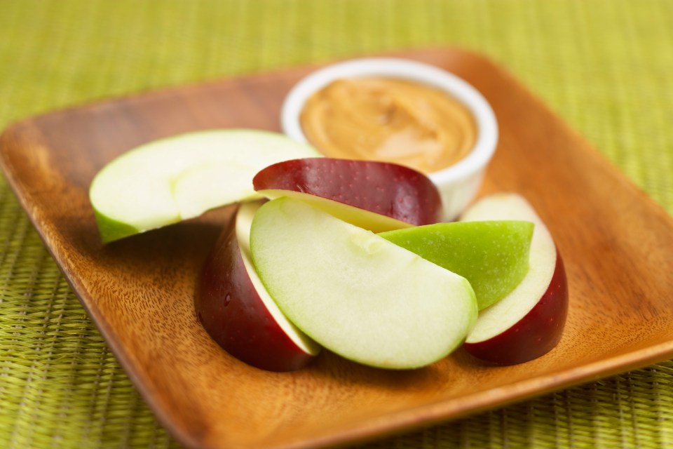 Cheap and healthy snack ideas include juicy apple slices with peanut – or any nut – butter