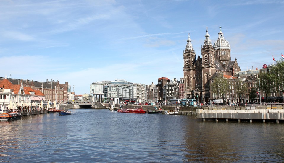 JCM3K8 Pedestrian and Bicycle Ferry crossing at the IJ River behind Central Station in Amsterdam, Netherlands. Eye film museum and A'DAM tower in background