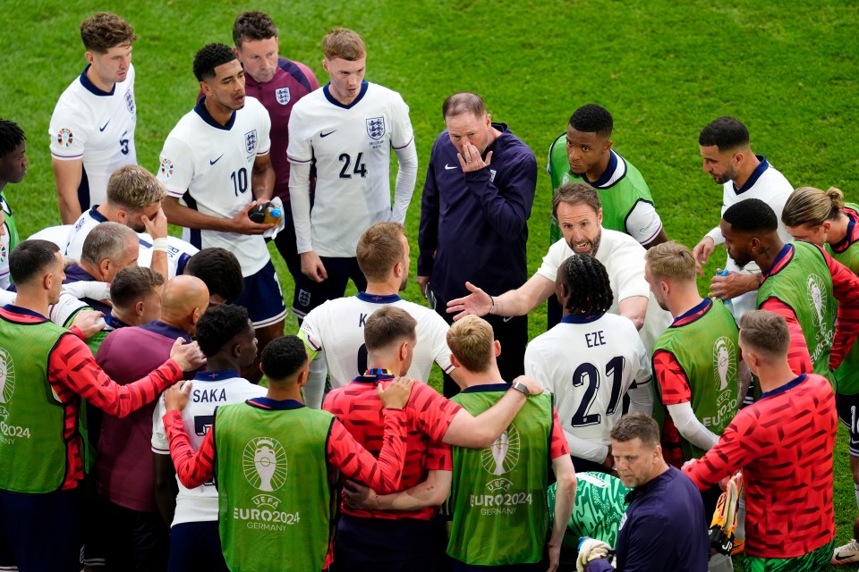 a group of soccer players are huddled together with one wearing the number 21