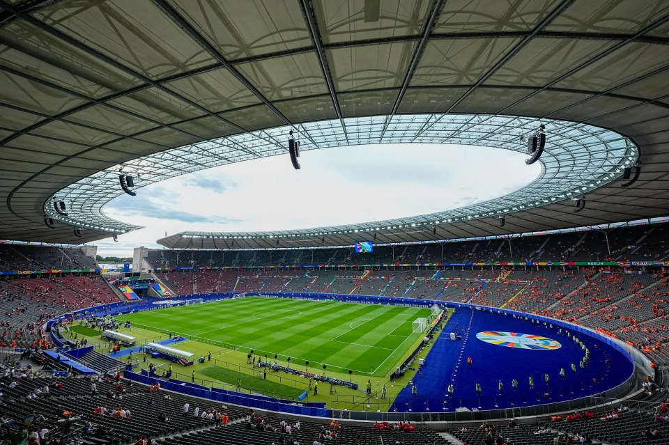 a large stadium with a soccer field in the middle