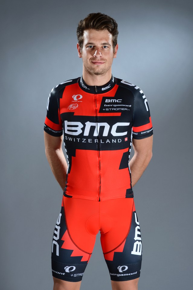 a man wearing a red and black bmc switzerland jersey