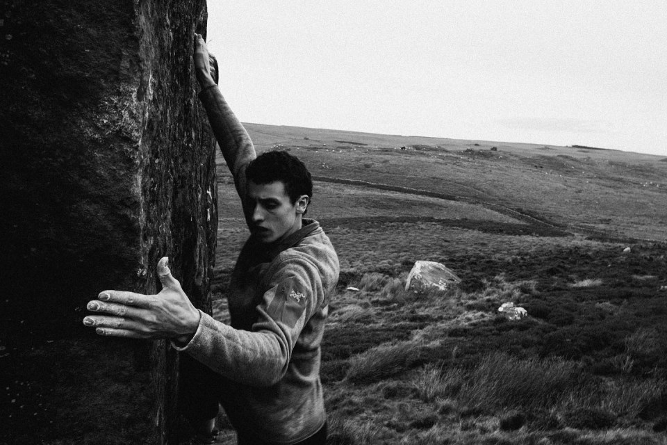 a man wearing a sweater with the word arcteryx on it