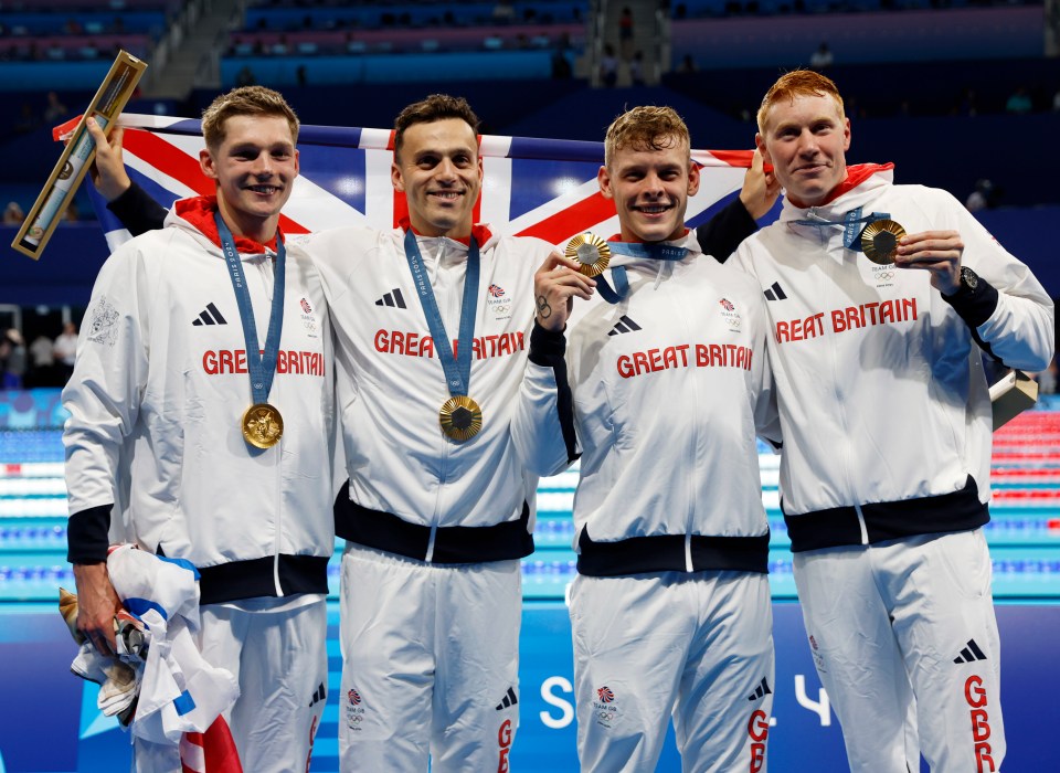 four great britain athletes are posing for a picture