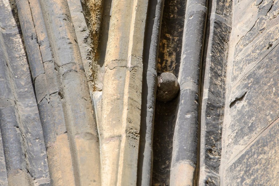 The ball got stuck in the mouldings after a little boy named Gilbert Bell threw it too high as he played with his brother in 1914