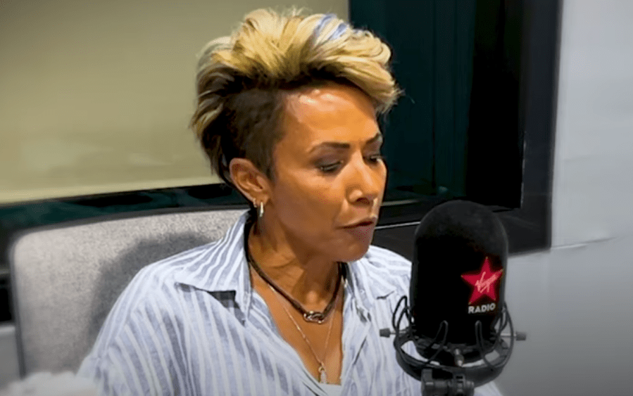 a woman speaking into a virgin radio microphone