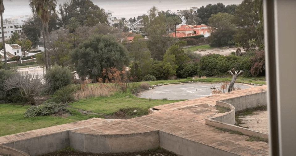 a view of a residential area with a swimming pool in the foreground