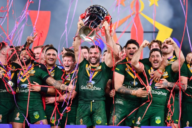 a group of rugby players celebrating with a trophy that says gallagher on it