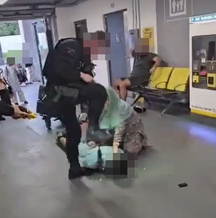 Footage showed a policeman stamping on someone's head at Manchester Airport