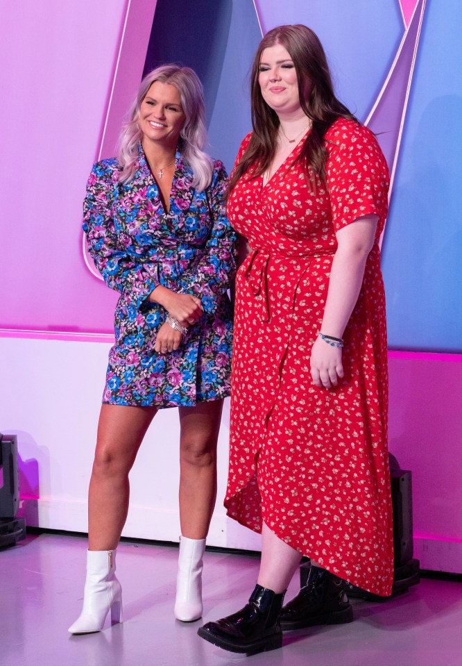 two women standing next to each other with one wearing a red dress