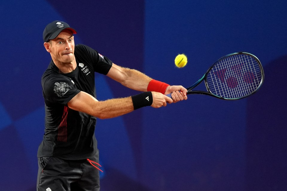 tennis player wearing a black shirt that says ' british and irish lions ' on it