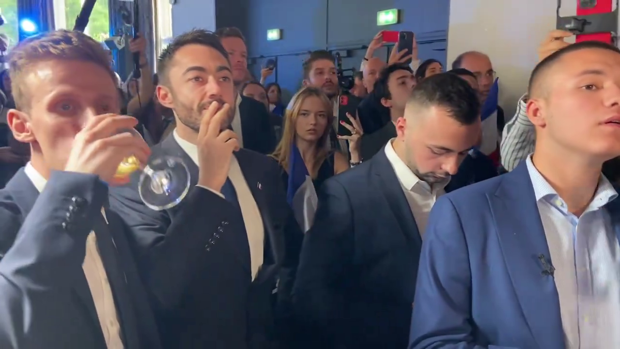 Members of Marine Le Pen's far-right National Rally party drinking champagne before realising their election defeat