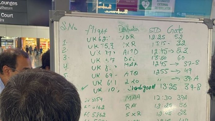 A pen-and-whiteboard departures board at Manchester Airport yesterday