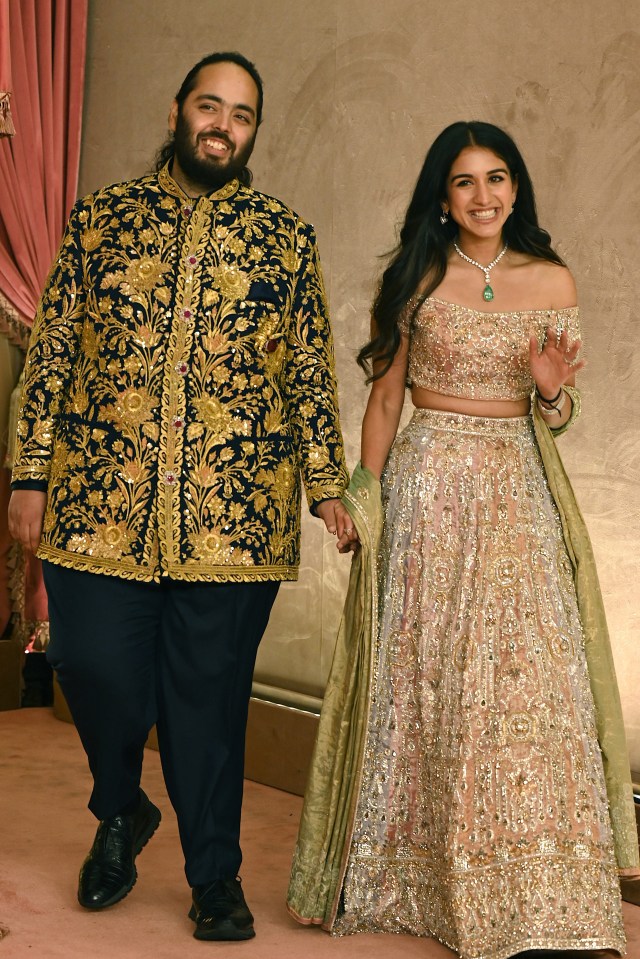 a man and a woman are holding hands and smiling