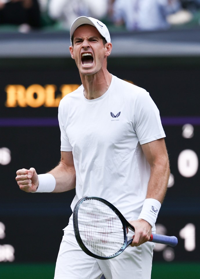 a man holding a tennis racquet in front of a rolex sign