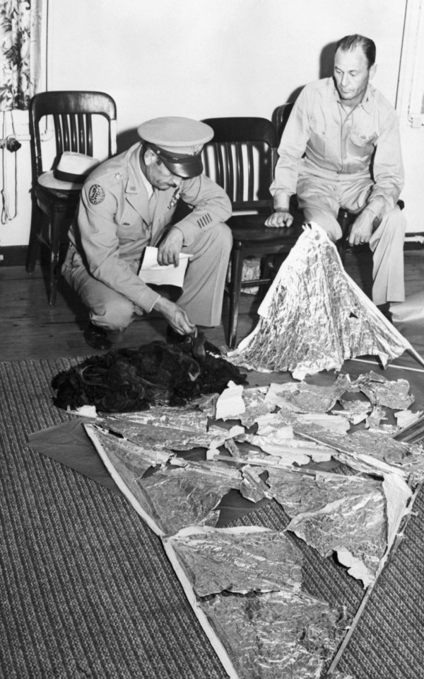 Brig. General Roger M. Ramey and Col. Thomas J. Dubose identify metallic fragments as pieces of a weather balloon