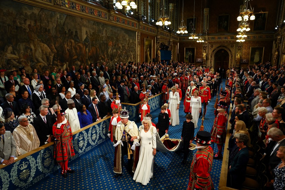 King Charles III and Queen Camilla process through the Royal Gallery during the State Opening of Parliament at the Houses of Parliament