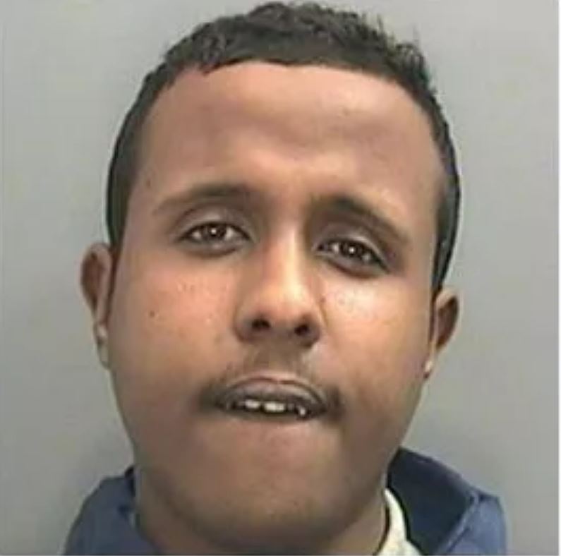 a close up of a man 's face with a blue jacket on .