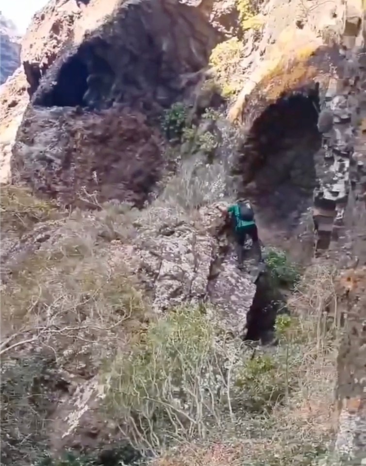 Rescuers were seen scouring rock faces as they faced the 'dangerous' terrain