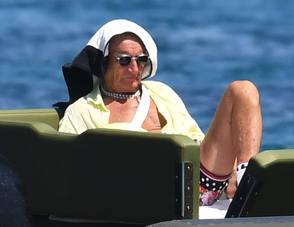 He covered up from the baking heat in Porto Cervo, Sardinia, by wrapping a towel around his head