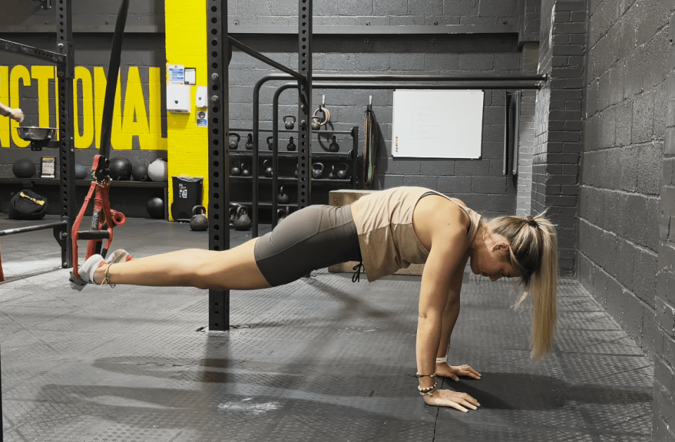 Plank position in a TRX