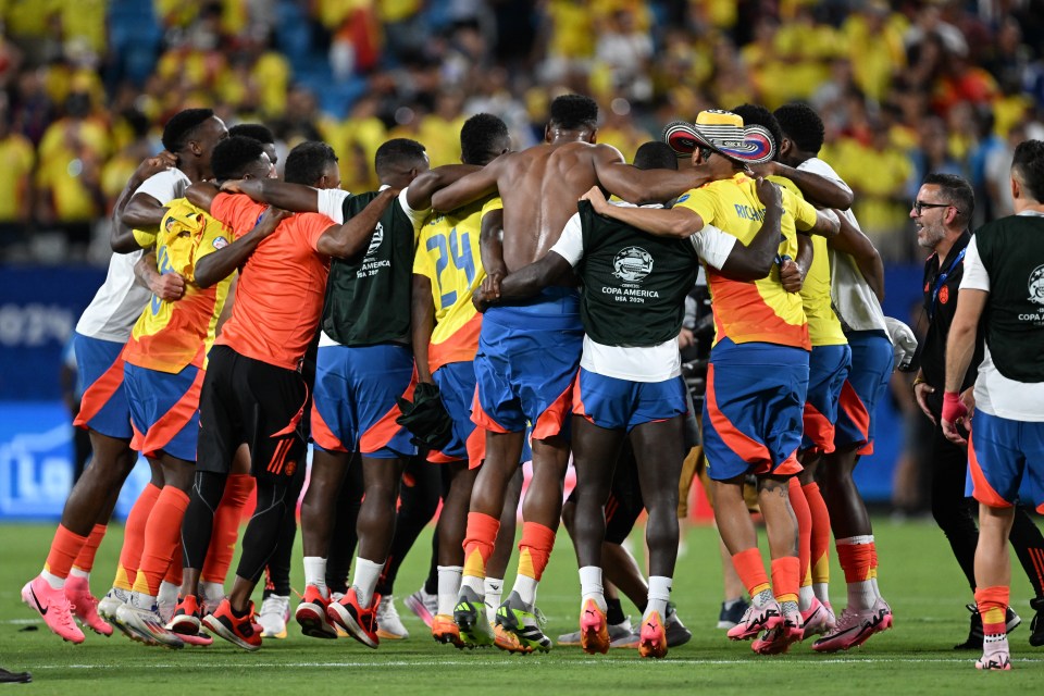 a group of soccer players huddle together with one wearing number 24