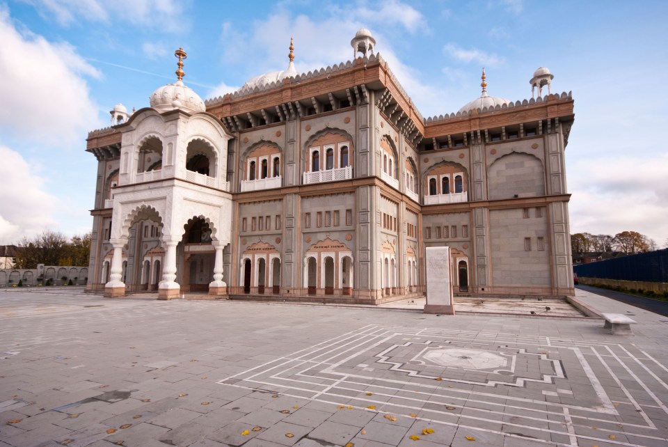 a large building with a maze in front of it