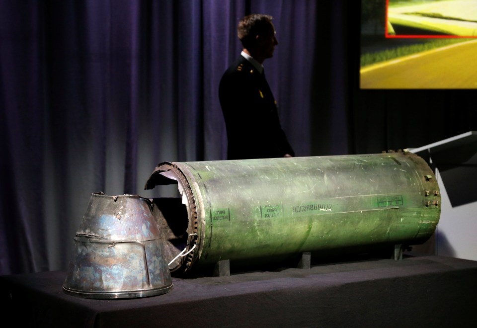 A damaged missile is displayed during a news conference by members of the Joint Investigation Team