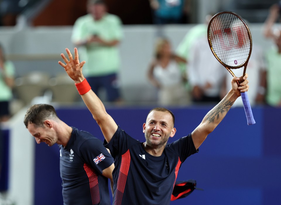 a man holding a tennis racquet with the word wilson on it