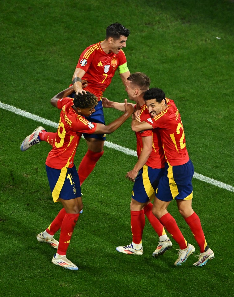 a group of soccer players one of whom has the number 9 on his jersey