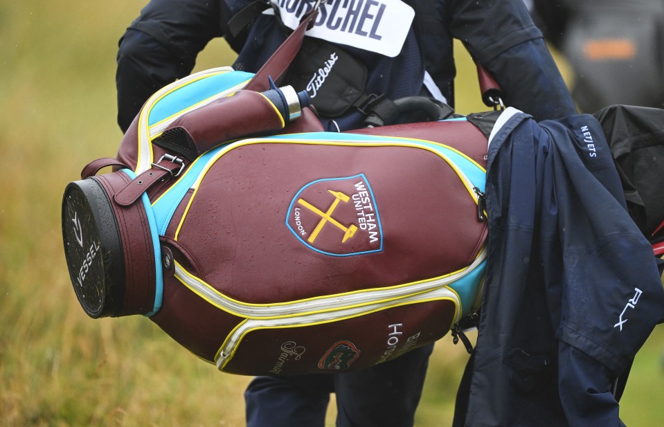 a person carrying a west ham golf bag