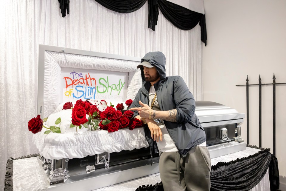 Eminem attends The Death of Slim Shady pop-up in London, above an open coffin with the ‘corpse’ of his alter ego Slim Shady was on display