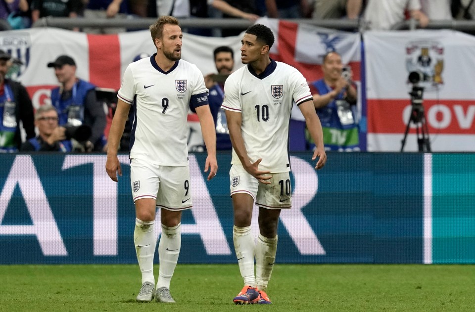 two soccer players on a field with the word atari in the background