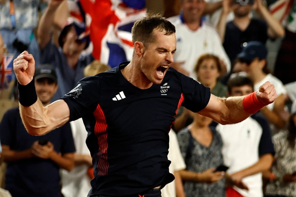 a man wearing an adidas shirt celebrates in front of a crowd