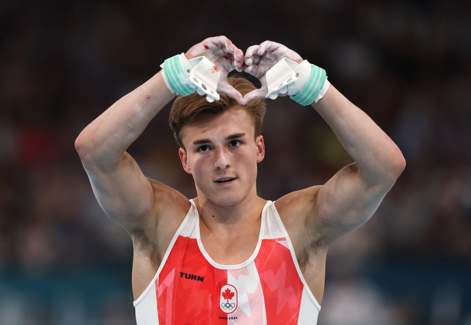 a man wearing a red and white tank top with the word turn on it