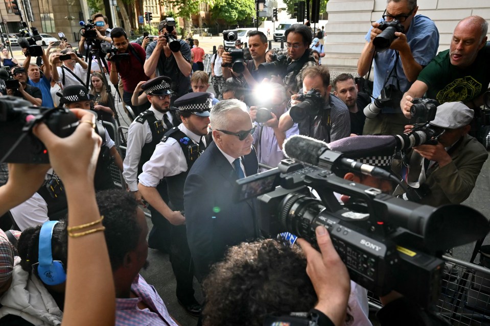 He was surrounded by police as he made his way into court today