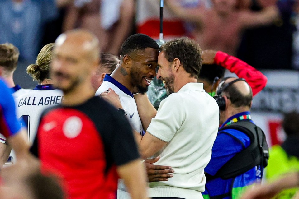 a man in a gallagher jersey is hugging another man