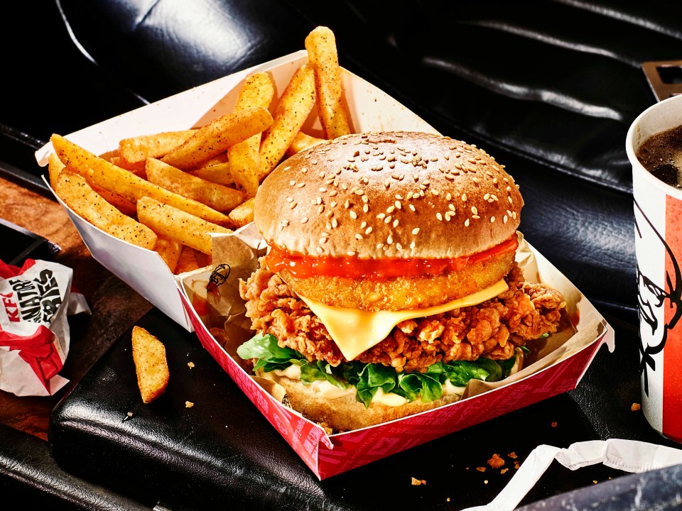 a hamburger and french fries in a kfc container