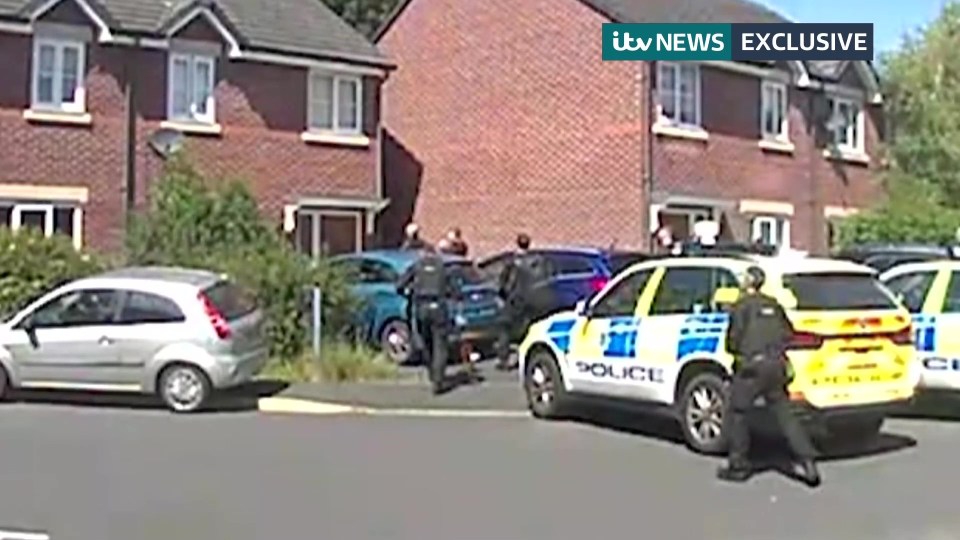 a group of police cars are parked in front of a brick house