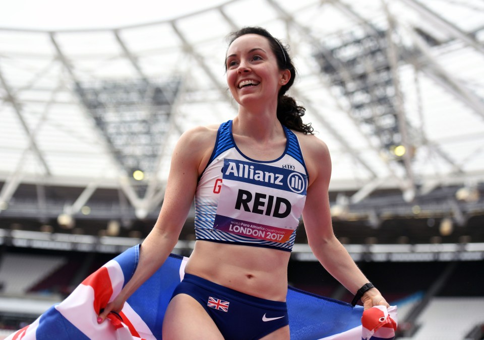 a woman wearing a allianz top is holding a british flag