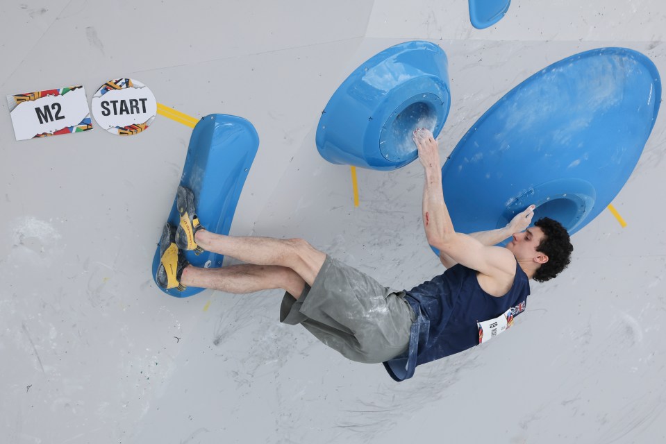 a man climbing a wall with a sign that says m2 on it