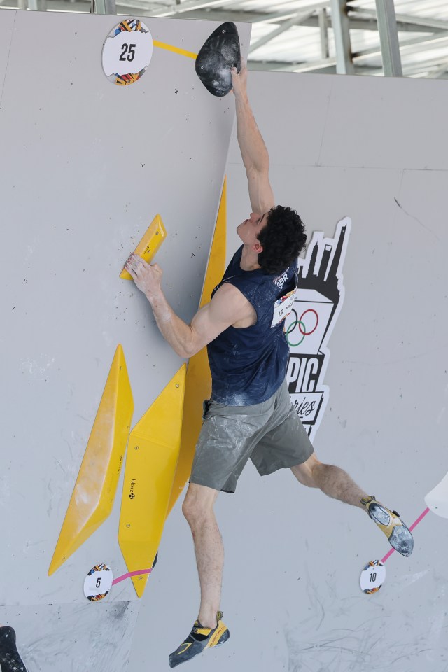 a man is climbing a wall with the number 25 on it