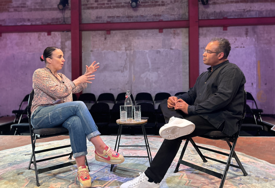 a man and a woman are sitting in chairs talking to each other